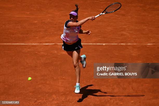 Belgium's Elise Mertens returns the ball to Romania's Simona Halep during their 2021 WTA Tour Madrid Open tennis tournament singles match at the Caja...