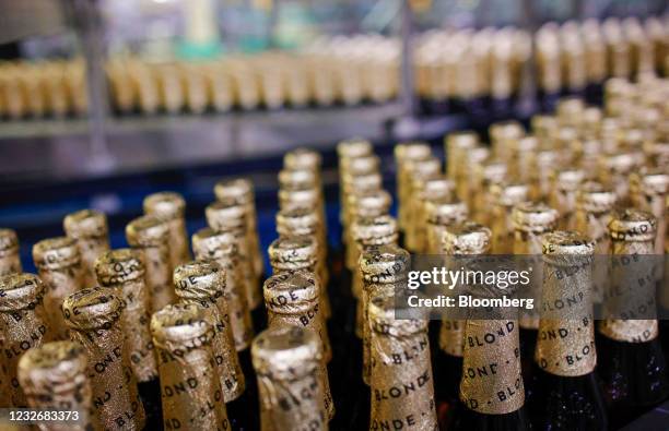 Bottles of Leffe Blonde beer on a conveyor at the Anheuser-Busch InBev NV brewery in Leuven, Belgium, on Tuesday, May 4, 2021. AB Inbev reports first...