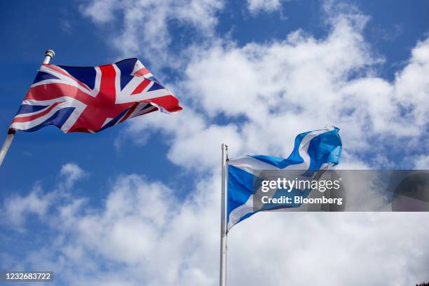The British Union flag, also known as the Union Jack, left, and the saltire, the national flag of Scotland, right, in a garden in North Ayrshire,...