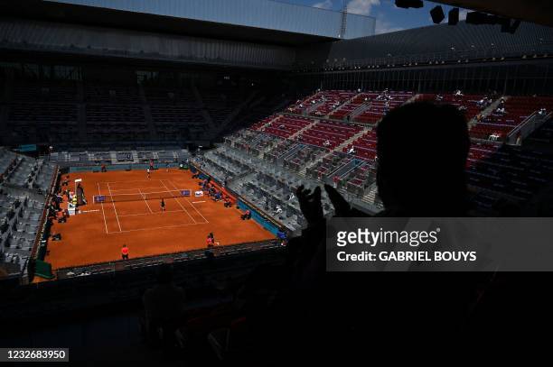 Spectator applauds during the 2021 WTA Tour Madrid Open tennis tournament singles match between Belgium's Elise Mertens and Romania's Simona Halep at...