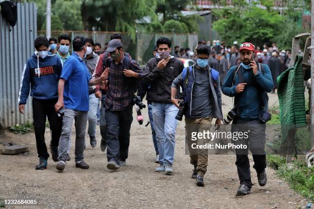Kashmiri Journalists walk for coverage towards an encounter site on the Outskirts of Sopore, District Baramulla, Jammu and Kashmir, India on 04 May...