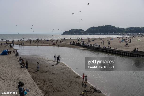 People relax on Yuigahama Beach on May 4, 2021 in Kamakura, Japan. As Japan enjoys its annual Golden Week holiday a number of prefectures, including...