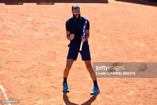 France's Benoit Paire celebrates winning the first set to Georgia's Nikoloz Basilashvili during their 2021 ATP Tour Madrid Open tennis tournament...