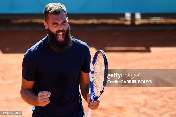 France's Benoit Paire celebrates winning the first set to Georgia's Nikoloz Basilashvili during their 2021 ATP Tour Madrid Open tennis tournament...