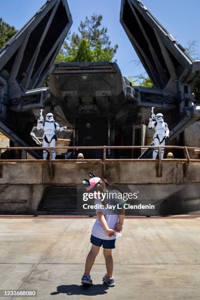 Young girl stops in front of Kylo Ren and Storm Trooper role players in Galaxys Edge at Disneyland Resort in Anaheim, CA, as visitors return to the...