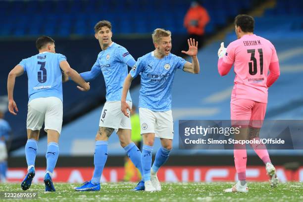 Oleksandr Zinchenko of Manchester City congratulates goalkeeper Ederson on his assist for the first City goal during the UEFA Champions League Semi...