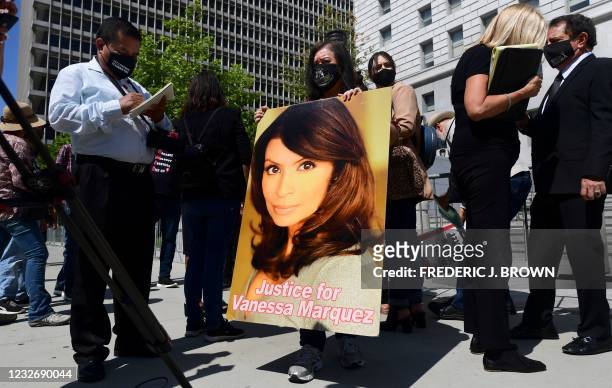 Minerva Garcia holds a portait of her slain friend Vanessa Marquez, an actress shot and killed by police in her South Pasadena home in 2018 during a...