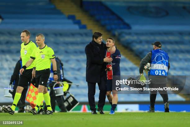 Coach Mauricio Pochettino consoles Marco Verratti after their loss during the UEFA Champions League Semi Final Second Leg match between Manchester...