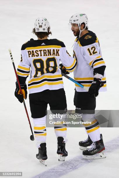 Boston Bruins right wing David Pastrnak and Boston Bruins right wing Craig Smith talk prior to the National Hockey League game between the New Jersey...
