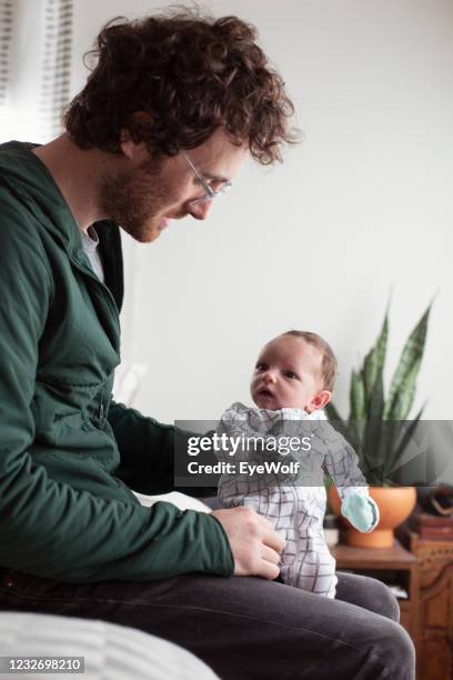 father burping newborn daughter. - burping stock-fotos und bilder