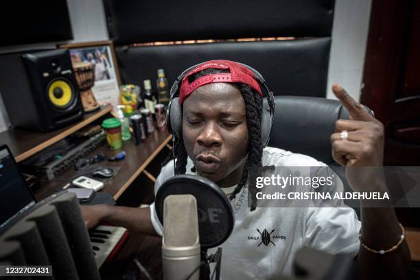 Ghana Afropop musician, Stonebwoy, sings during a recording session at his studio in his house in Accra, Ghana, on March 25, 2021. - In a music scene...