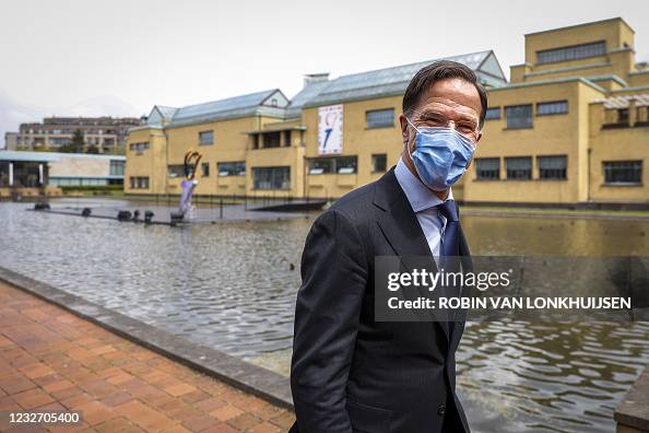Dutch Prime Minister Mark Rutte, wearing a face mask, arrives to ...