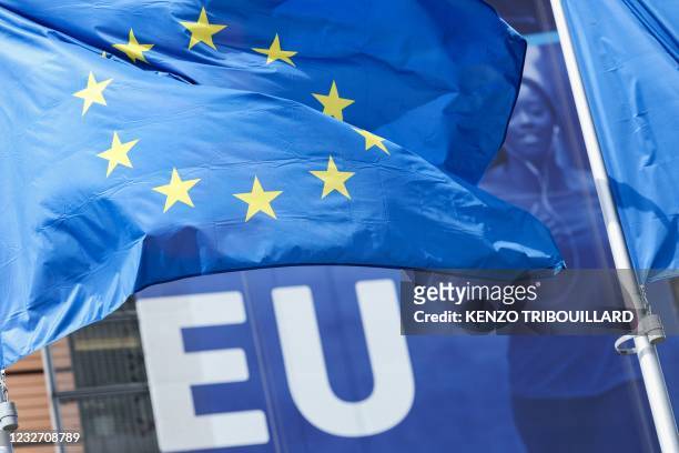 Picture taken on May 5, 2021 shows a flag of the European Union flying outside the European commission headquarters in Brussels.