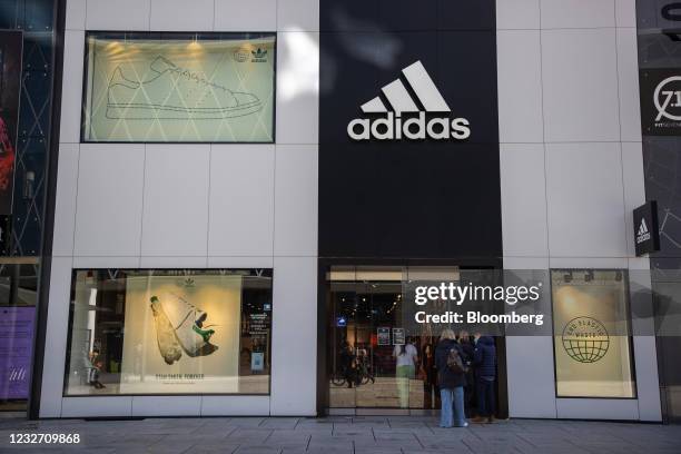 Customers wait for 'click and collect' orders outside an Adidas AG store in Frankfurt, Germany, on Wednesday, May 5, 2021. Adidas reports first...