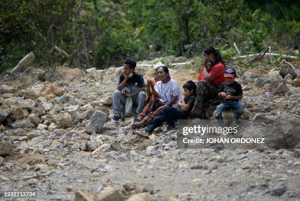 This photo taken on April 30 shows 32-year-old Erwin Cal with members of his family at the site of a landslide that destroyed the Guatemalan village...