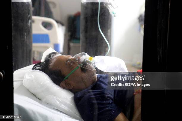 Covid-19 infected patient receiving medical oxygen for breathing comfortably seen inside a Covid care center of the Commonwealth Games villages...