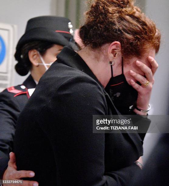 The victim's widow Rosa Maria Esilio cries as she leaves after the court decision in the trial of two US citizens on charges of murdering her...