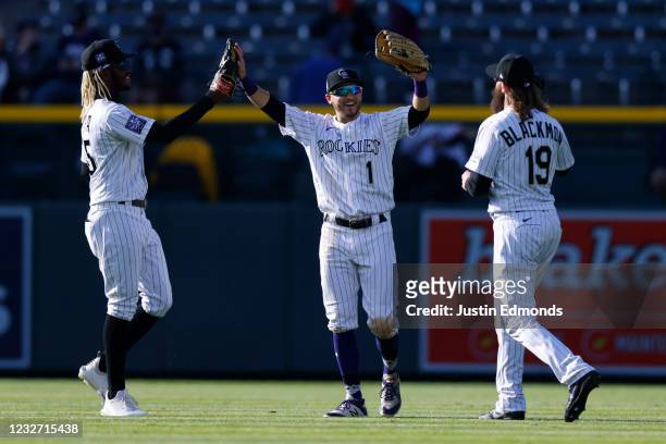 Raimel Tapia, Garrett Hampson and Charlie Blackmon of the Colorado Rockies celebrate their 6-5 win against the San Francisco Giants at Coors Field on...