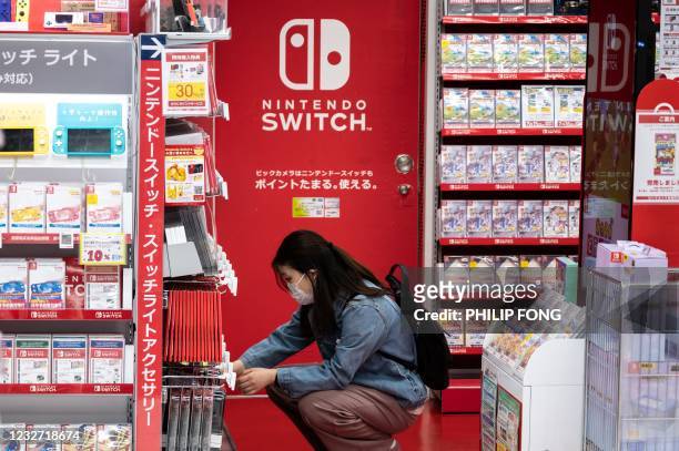 Customer browses the gaming section of Nintendo products in a shop in Tokyo on May 6, 2021.