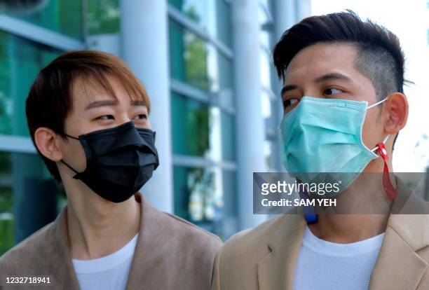 Taiwanese Ting Tse-yen and his Macau same sex partner Leong Chin-fai speak to press in front of Taipei High Administrative Court after winning the...