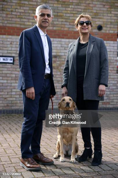 Labour candidate for London Mayor Sadiq Khan poses for a photo with his wife, Saadiya Khan, and their dog Luna outside a polling station in Tooting...