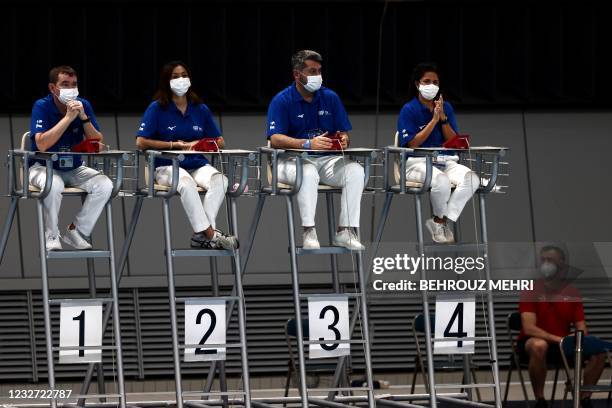 Judges wearing face masks wait for the start of the men's 3m springboard final at the FINA Diving World Cup and test event for the Tokyo 2020 Olympic...