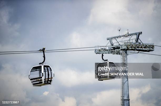 Gondolas hang on the 850 meter long cable, which will transport visitors over the A6 highway to the Floriade 2022 horticultural exhibition center in...