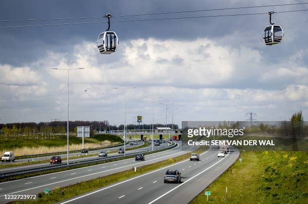 Gondolas hang on the 850 meter long cable, which will transport visitors over the A6 highway to the Floriade 2022 horticultural exhibition center in...