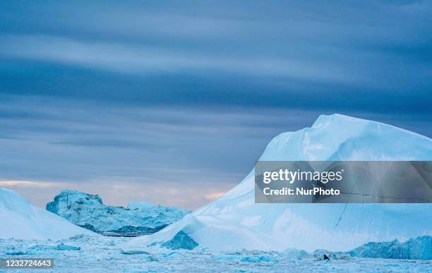 Icebergs near Ilulissat, Greenland. Climate change is having a profound effect in Greenland with glaciers and the Greenland ice cap retreating.