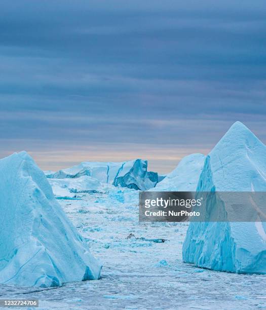 Icebergs near Ilulissat, Greenland. Climate change is having a profound effect in Greenland with glaciers and the Greenland ice cap retreating.