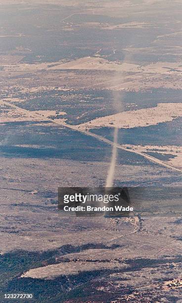 Dust devil, kicked up by hot dry winds, swirls dirt and ash into the air after a wild fire burned thousands of acres September 1, 2011 in flight...