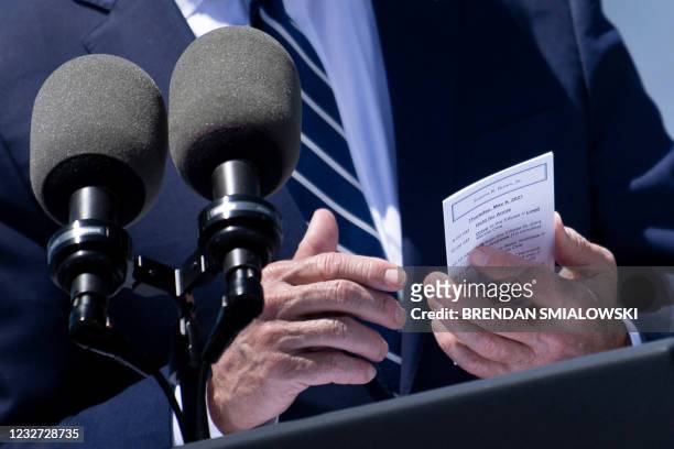 President Joe Biden shows his schedule while speaking about infrastructure and jobs along the banks of the Calcasieu River near Interstate 10 on May...