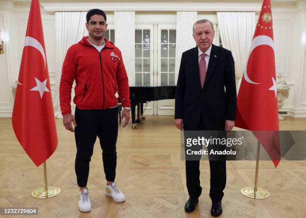 Turkish President Recep Tayyip Erdogan poses for a photo with Turkish wrestlers Taha Akgul during his iftar dinner with national athletes who won...