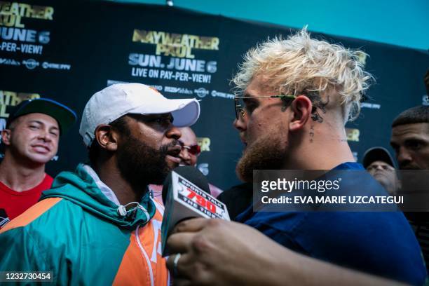 Floyd Mayweather and Jake Paul pose during a press conference at Hard Rock Stadium, in Miami Gardens, Florida, on May 6, 2021. - Former world...
