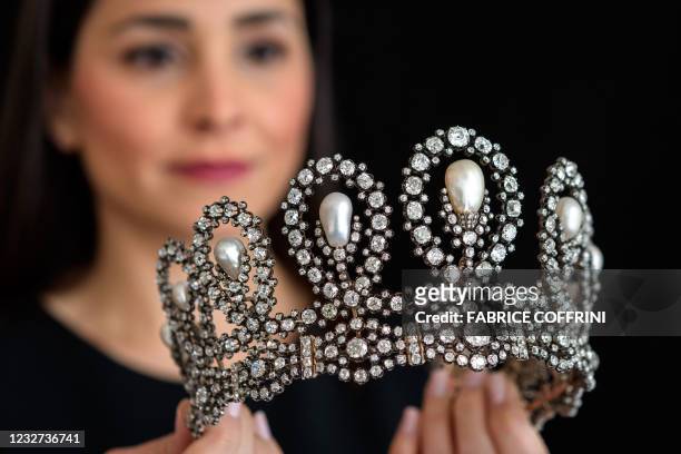 Model poses on May 6, 2021 with an historic natural pearl and diamond tiara from the second half of the 19th century which has remained with the...
