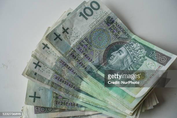 Pile of 100 Polish zlotys banknotes is seen in Gdansk, Poland on 14 April 2021