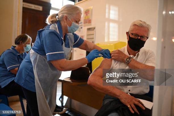 Health worker injects a dose of the AstraZeneca/Oxford Covid-19 vaccine at a temporary vaccine centre set up at City Hall in Hull, northeast England...