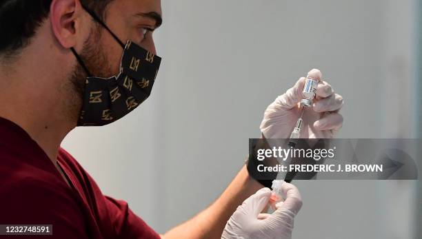 Pharmacy student Norbek Gharbian prepares a Johnson & Johnson Covid19 vaccine on May 7, 2021 in Los Angeles, California, at a vaccination clinic...