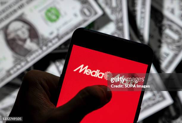 In this photo illustration the German electronics multinational chain of stores Media Markt logo seen displayed on a smartphone with USD currency in...