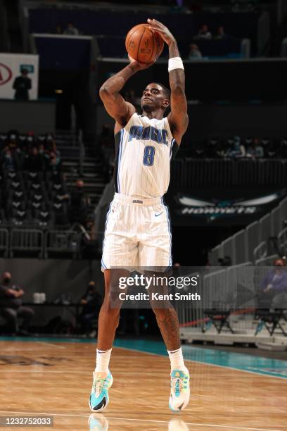 Dwayne Bacon of the Orlando Magic shoots a three point basket during the game against the Charlotte Hornets on May 7, 2021 at Spectrum Center in...