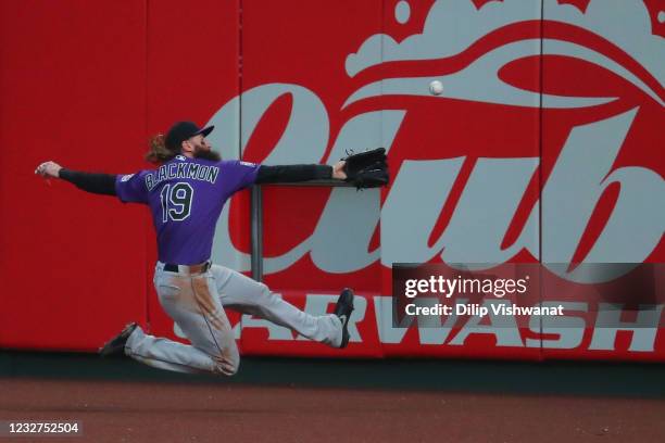 Charlie Blackmon of the Colorado Rockies attempts to catch fly ball \ass\ in the second inning at Busch Stadium on May 7, 2021 in St Louis, Missouri.