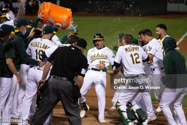 Seth Brown of the Oakland Athletics is congratulated by teammates after hitting a walkoff home run against the Tampa Bay Rays during the ninth inning...