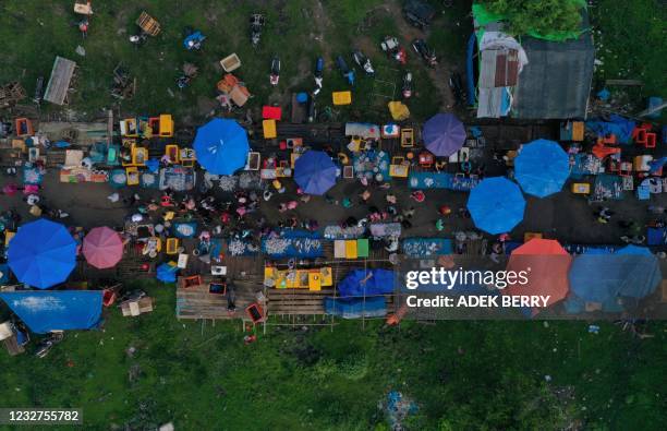 This aerial photo shows people at a fish market in Pulau Baai, Bengkulu on May 8, 2021.