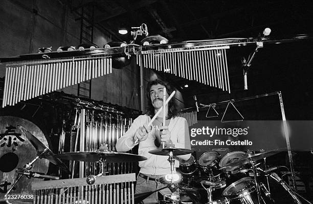 Neil Peart, drummer with Canadian rock band Rush, behind his drumkit, with miniature tubular bells hanging down, during a soundcheck ahead of the...