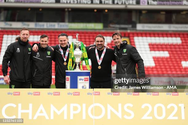 Daniel Farke the head coach / manager of Norwich City and his coaching stand celebrate with the Sky Bet Championship trophy during the Sky Bet...