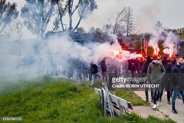 Feyenoord fans hold flares in Rotterdam, on May 8 during gathering at the team's training field despite Covid-19 restrictions ahead of the run-up to...