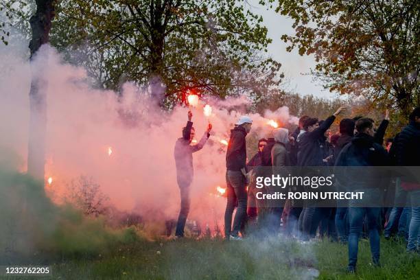 Feyenoord fans throw fireworks and stones at the police in Rotterdam, on May 8 after they came to Feyenoord's training field to cheer the players...