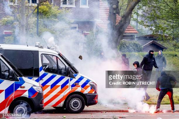 Feyenoord fans throw fireworks and stones at the police in Rotterdam, on May 8 after they came to Feyenoord's training field to cheer the players...