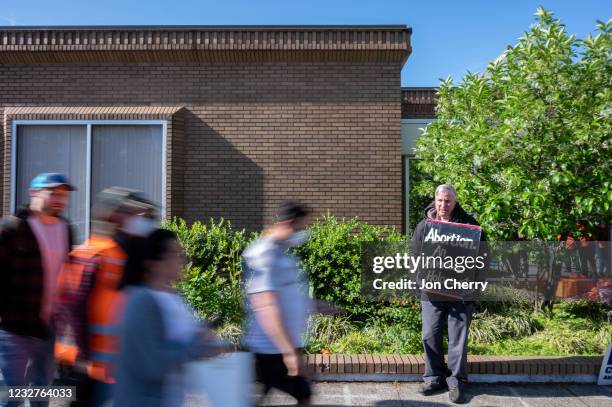 Pro-life demonstrators attempt to convince a patient surrounded by volunteer clinic escorts not to enter the EMW Women's Surgical Center, an abortion...