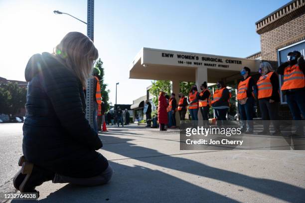 Pro-life demonstrator prostrates before a line of volunteer clinic escorts in front of the EMW Women's Surgical Center, an abortion clinic, on May 8,...